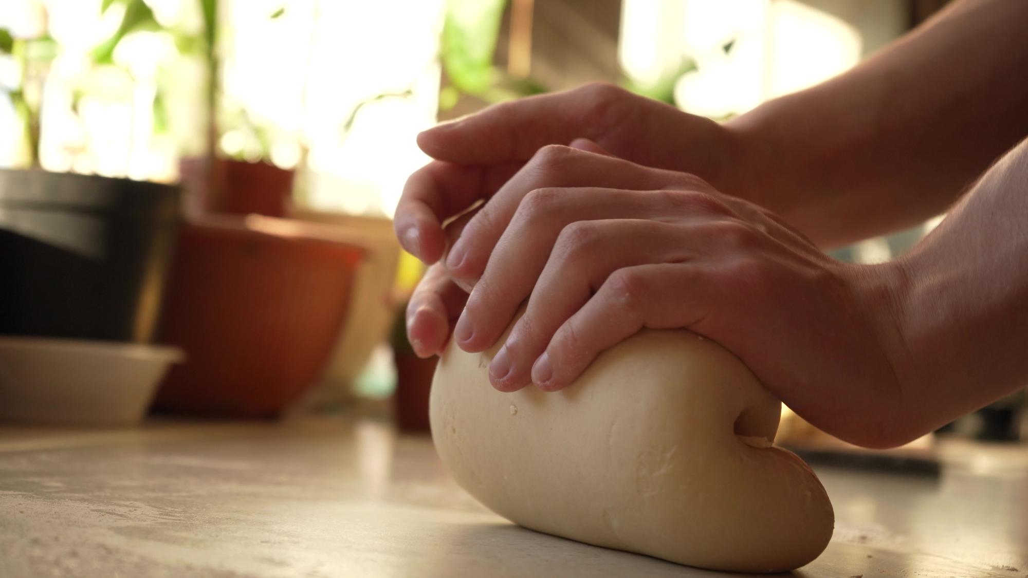 Hands kneading dough